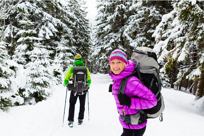 Couple snowshoeing in winter scene